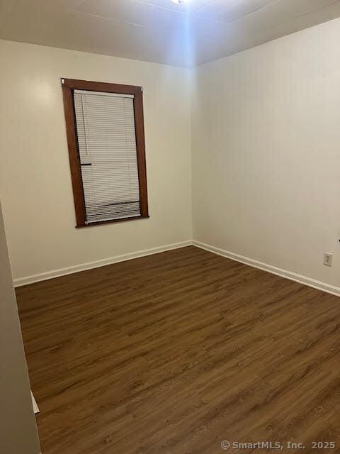 40 Orchard St, Bristol, CT 06010 - empty room featuring dark wood-type flooring and baseboards