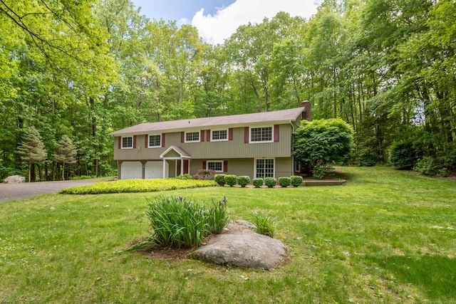 4 Leopard Dr, Newtown, CT 06482 - view of front of home featuring asphalt driveway, a garage, a front yard, and a chimney