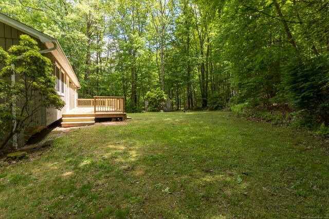 4 Leopard Dr, Newtown, CT 06482 - view of grassy yard with a wooden deck and a view of trees