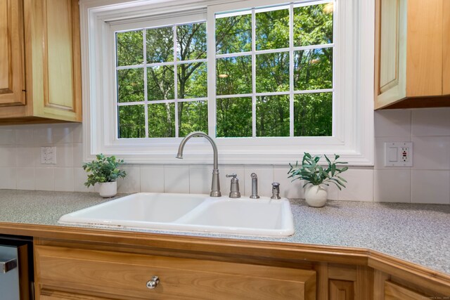 4 Leopard Dr, Newtown, CT 06482 - kitchen view of a sink, light countertops, and backsplash