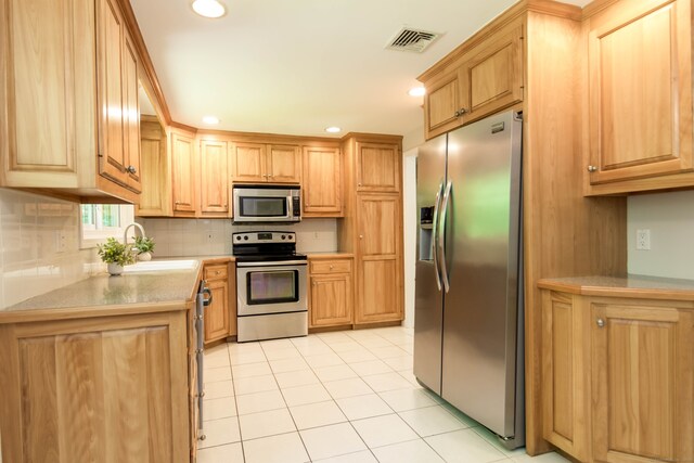 4 Leopard Dr, Newtown, CT 06482 - kitchen with stainless steel appliances, a sink, light tile patterned floors, decorative backsplash, and recessed lighting