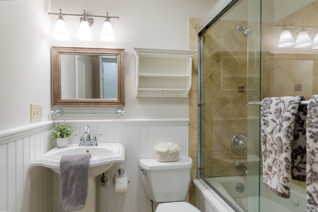 4 Leopard Dr, Newtown, CT 06482 - full bath with toilet, combined bath / shower with glass door, wainscoting, and a decorative wall
