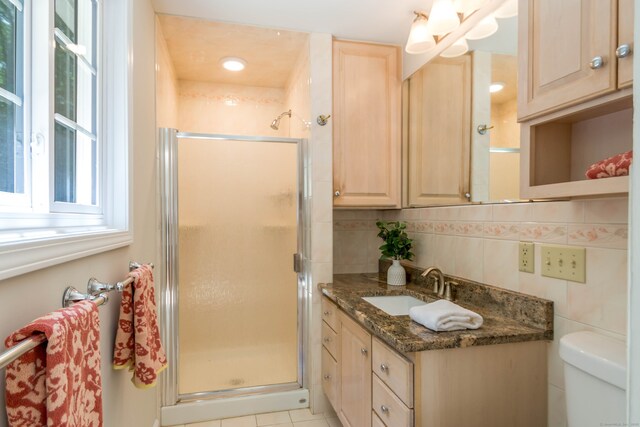 4 Leopard Dr, Newtown, CT 06482 - full bathroom featuring vanity, a shower stall, tile walls, and toilet