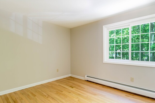 4 Leopard Dr, Newtown, CT 06482 - empty room featuring baseboard heating, wood finished floors, and baseboards