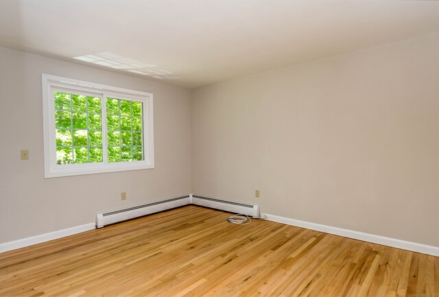 4 Leopard Dr, Newtown, CT 06482 - spare room with light wood-type flooring, baseboards, and a baseboard heating unit