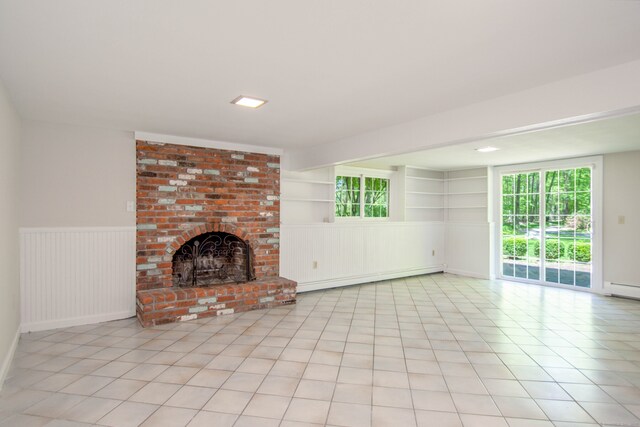 4 Leopard Dr, Newtown, CT 06482 - unfurnished living room featuring a baseboard heating unit, a brick fireplace, light tile patterned floors, and a wainscoted wall
