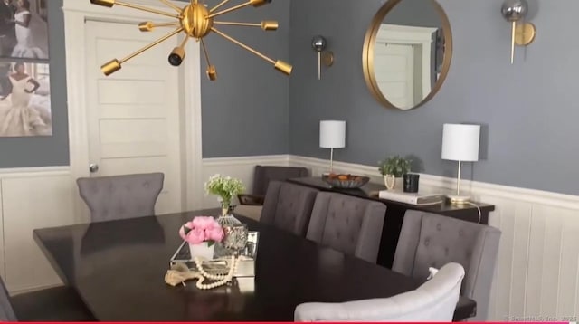 392 Laurel Ave, Bridgeport, CT 06605 - dining area featuring a wainscoted wall and a chandelier