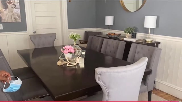 392 Laurel Ave, Bridgeport, CT 06605 - dining space featuring a wainscoted wall, a decorative wall, and wood finished floors