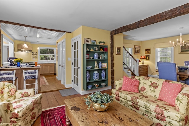 94 Glen Rd, Newtown, CT 06482 - living area featuring wood-type flooring, a chandelier, stairway, and beam ceiling