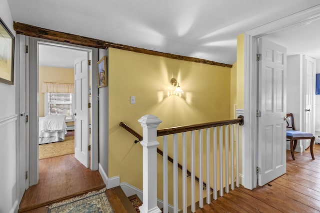 94 Glen Rd, Newtown, CT 06482 - hallway with an upstairs landing, wood-type flooring, a baseboard heating unit, and baseboards