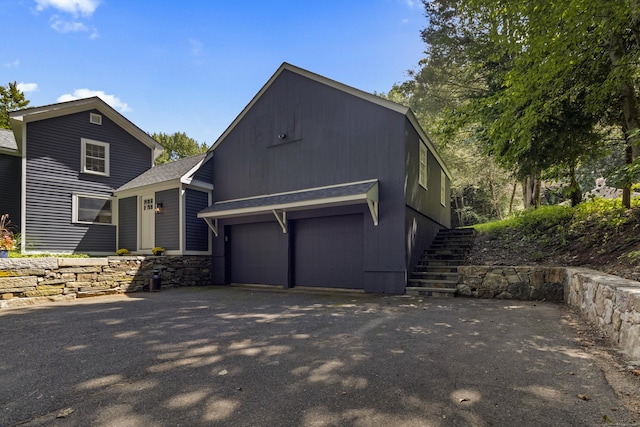 94 Glen Rd, Newtown, CT 06482 - view of front facade featuring driveway, roof with shingles, and stairway