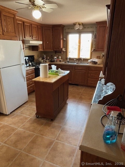 78 Pleasant View Rd, Thomaston, CT 06787 - kitchen featuring freestanding refrigerator, under cabinet range hood, a sink, ceiling fan, and light tile patterned floors