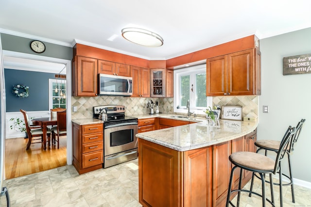 7 Broadview Rd, Brookfield, CT 06804 - kitchen with appliances with stainless steel finishes, brown cabinetry, a peninsula, light stone counters, and a kitchen breakfast bar