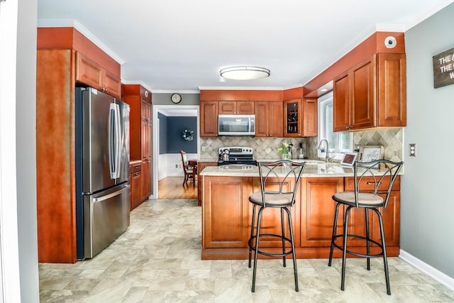 7 Broadview Rd, Brookfield, CT 06804 - kitchen featuring appliances with stainless steel finishes, a peninsula, tasteful backsplash, glass insert cabinets, and a kitchen bar