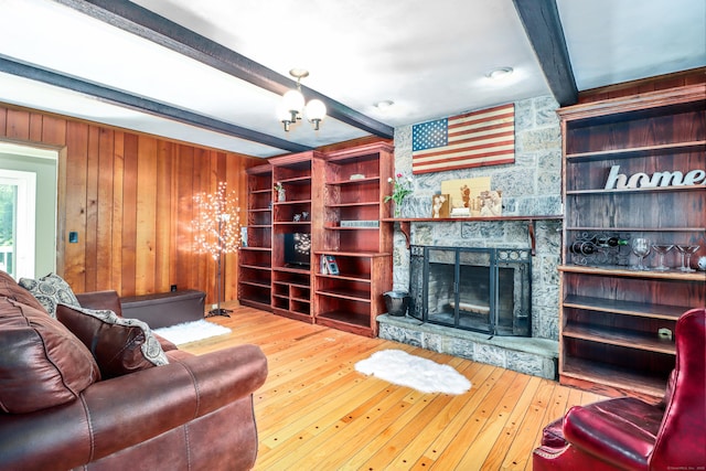 7 Broadview Rd, Brookfield, CT 06804 - living room with beamed ceiling, a chandelier, a fireplace, wood-type flooring, and wood walls