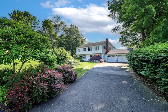 7 Broadview Rd, Brookfield, CT 06804 - colonial-style house featuring a chimney, driveway, and a garage