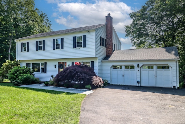 7 Broadview Rd, Brookfield, CT 06804 - colonial house with a chimney, a garage, asphalt driveway, and a front lawn