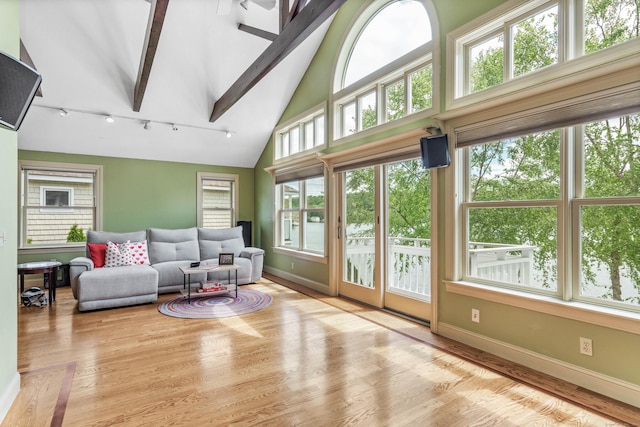 22 Lake Shore Dr, Middlefield, CT 06455 - living area with baseboards, rail lighting, beam ceiling, wood finished floors, and high vaulted ceiling