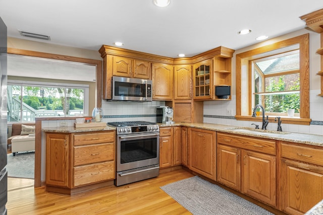 22 Lake Shore Dr, Middlefield, CT 06455 - kitchen featuring appliances with stainless steel finishes, a sink, open shelves, light stone counters, and recessed lighting