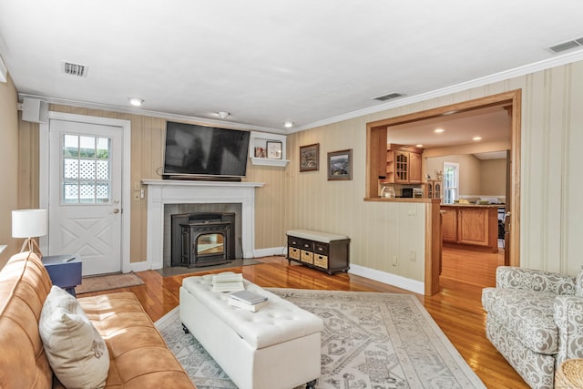 22 Lake Shore Dr, Middlefield, CT 06455 - living area with a wood stove, wood finished floors, crown molding, and baseboards