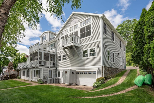 22 Lake Shore Dr, Middlefield, CT 06455 - back of house with a balcony, an attached garage, and a lawn