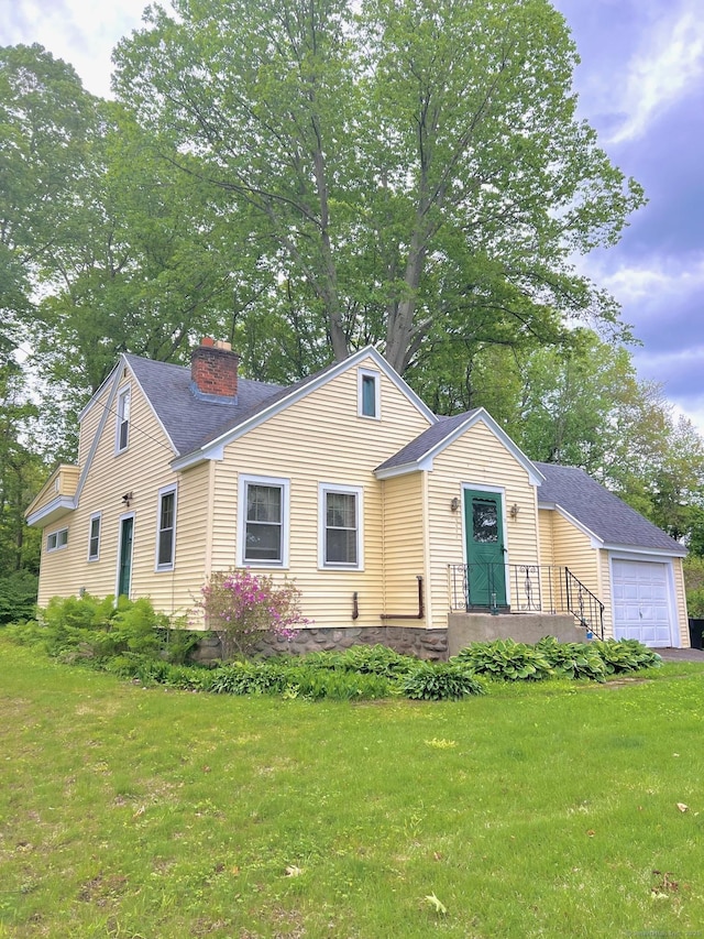 13 Oak St, Wolcott, CT 06716 - view of front of property featuring a garage, a chimney, a front lawn, and roof with shingles