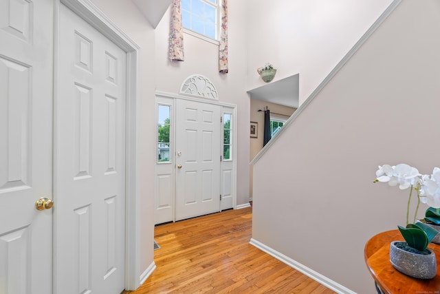 55 Oak Ridge Ln, Milford, CT 06461 - foyer featuring light wood-style flooring, baseboards, and a towering ceiling