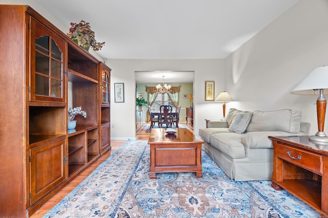55 Oak Ridge Ln, Milford, CT 06461 - living room featuring light wood-type flooring and a chandelier