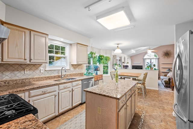 55 Oak Ridge Ln, Milford, CT 06461 - kitchen with stainless steel appliances, a sink, decorative backsplash, a kitchen island, and light stone counters