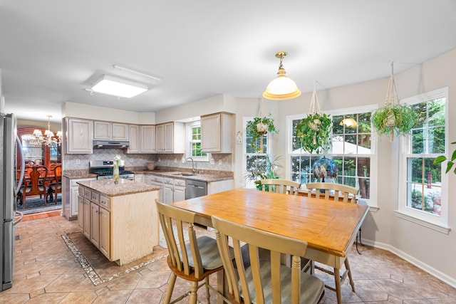 55 Oak Ridge Ln, Milford, CT 06461 - kitchen featuring appliances with stainless steel finishes, a sink, under cabinet range hood, decorative backsplash, and a kitchen island