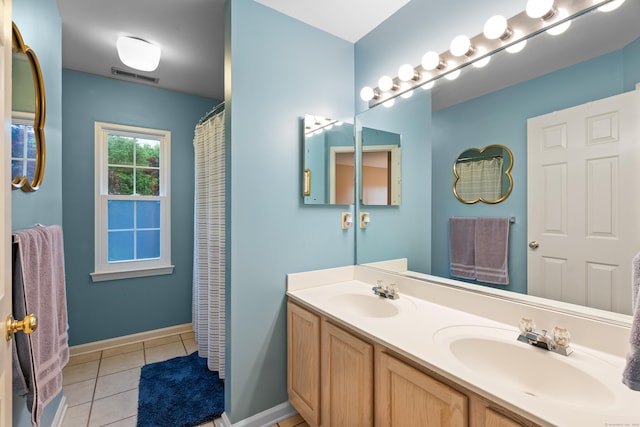 55 Oak Ridge Ln, Milford, CT 06461 - bathroom with tile patterned floors, double vanity, and baseboards