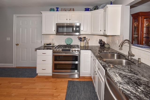 63 Hudson Ln Unit 63, Windsor, CT 06095 - kitchen with appliances with stainless steel finishes, a sink, white cabinetry, dark stone countertops, and tasteful backsplash