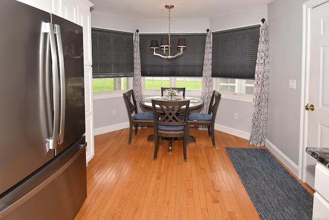 63 Hudson Ln Unit 63, Windsor, CT 06095 - dining area featuring a chandelier, light wood finished floors, and baseboards