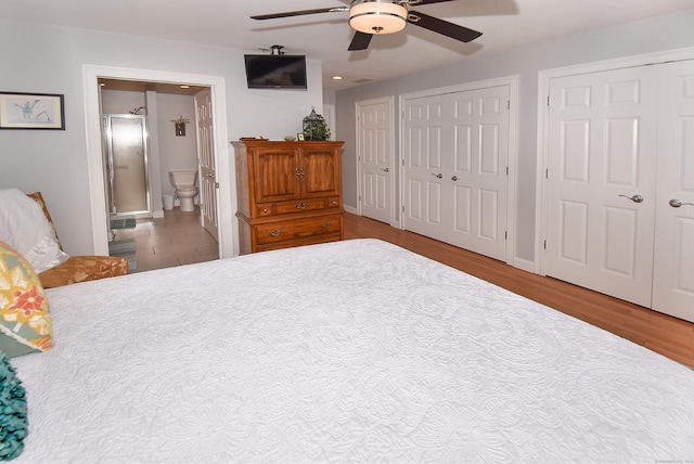 63 Hudson Ln Unit 63, Windsor, CT 06095 - bedroom featuring two closets, wood finished floors, ensuite bathroom, ceiling fan, and recessed lighting