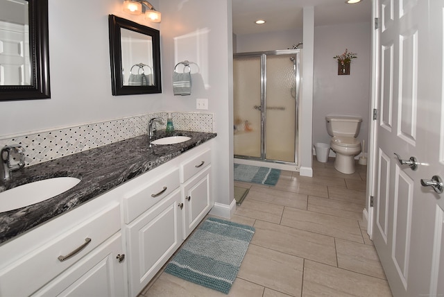 63 Hudson Ln Unit 63, Windsor, CT 06095 - bathroom with toilet, double vanity, a shower stall, recessed lighting, and baseboards