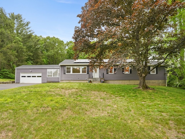 56 Great Neck Rd, Trumbull, CT 06611 - view of front facade with asphalt driveway, roof mounted solar panels, and a front lawn