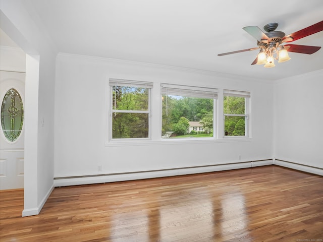 56 Great Neck Rd, Trumbull, CT 06611 - empty room featuring healthy amount of natural light, wood finished floors, ornamental molding, ceiling fan, and baseboard heating