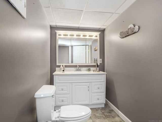 56 Great Neck Rd, Trumbull, CT 06611 - half bathroom with toilet, a paneled ceiling, vanity, and baseboards