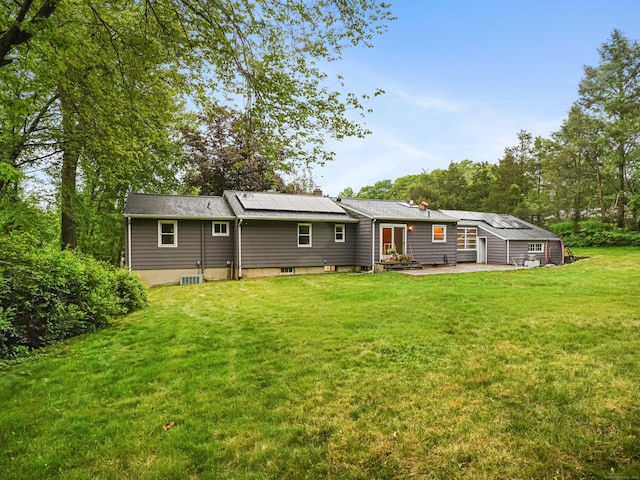 56 Great Neck Rd, Trumbull, CT 06611 - back of property featuring solar panels, a patio area, and a lawn
