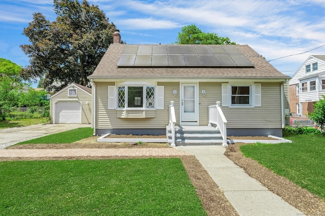 184 Merritt St, Bridgeport, CT 06606 - bungalow-style house with a front yard, an outdoor structure, solar panels, and a garage