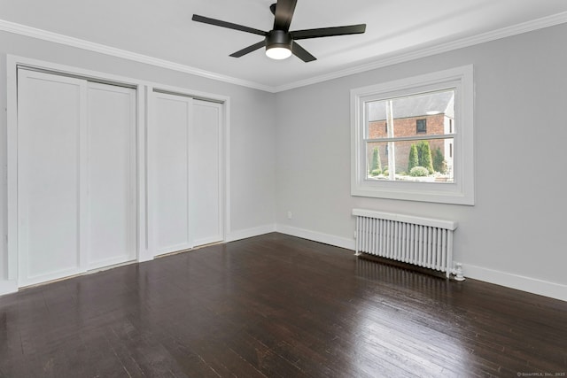 184 Merritt St, Bridgeport, CT 06606 - unfurnished bedroom with radiator heating unit, dark wood-style flooring, ornamental molding, baseboards, and two closets