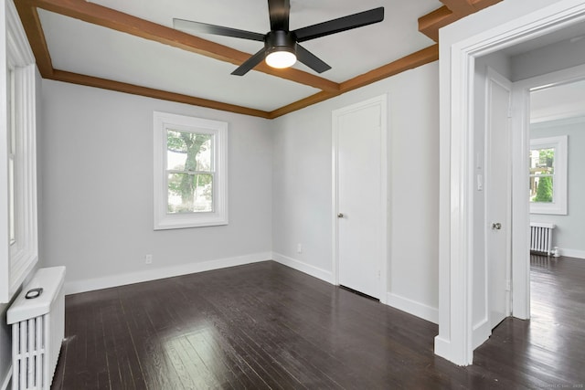184 Merritt St, Bridgeport, CT 06606 - unfurnished bedroom with radiator, multiple windows, and dark wood-style flooring