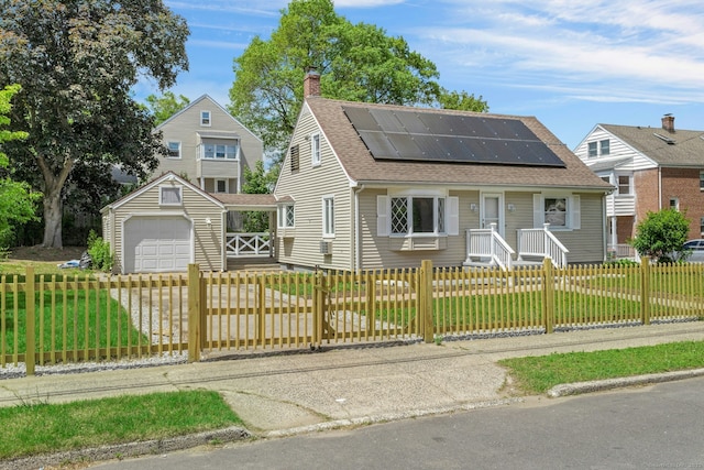 184 Merritt St, Bridgeport, CT 06606 - view of front facade featuring a chimney, a shingled roof, solar panels, an outdoor structure, and a detached garage