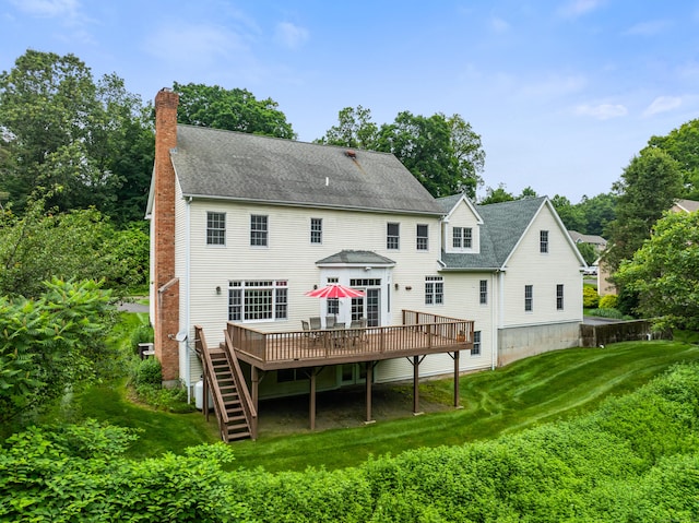 9 Autumn Leaves Rd, Wallingford, CT 06492 - back of house featuring a wooden deck, a chimney, a lawn, and roof with shingles