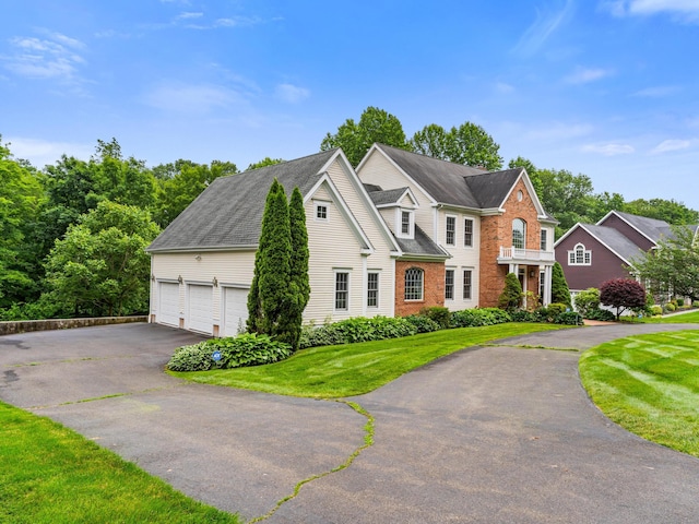 9 Autumn Leaves Rd, Wallingford, CT 06492 - view of front of home featuring driveway, a front lawn, and a garage