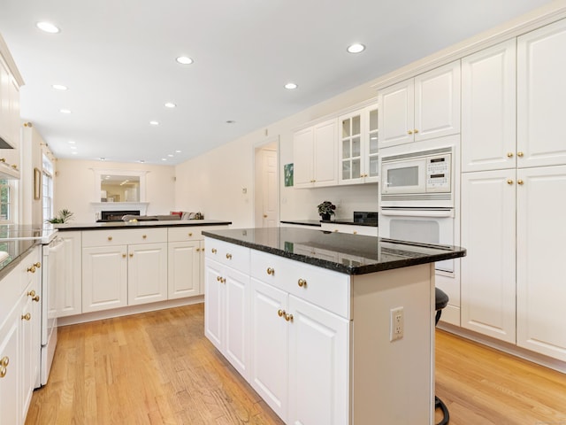 9 Autumn Leaves Rd, Wallingford, CT 06492 - kitchen with light wood-style flooring, white appliances, a kitchen island, white cabinetry, and recessed lighting