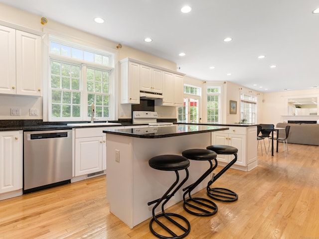 9 Autumn Leaves Rd, Wallingford, CT 06492 - kitchen with dishwasher, white range with electric cooktop, a kitchen bar, a kitchen island, and light wood-style flooring
