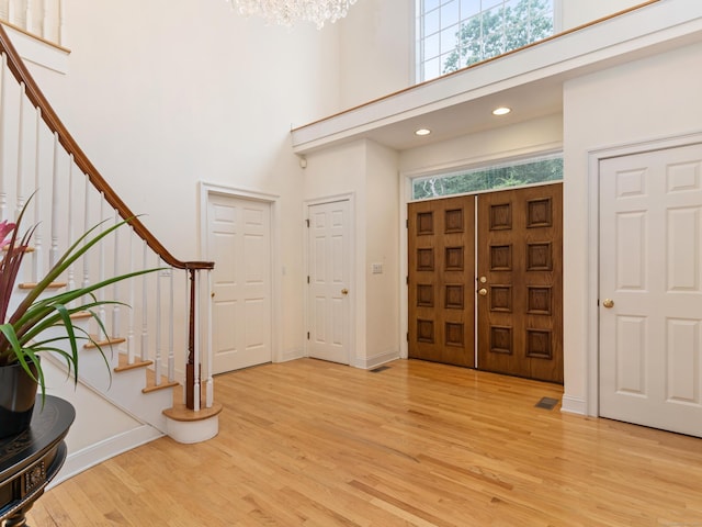 9 Autumn Leaves Rd, Wallingford, CT 06492 - foyer featuring stairway, a high ceiling, light wood-style flooring, a chandelier, and recessed lighting