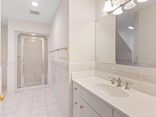 9 Autumn Leaves Rd, Wallingford, CT 06492 - full bath with tile walls, vanity, a shower stall, tile patterned flooring, and wainscoting