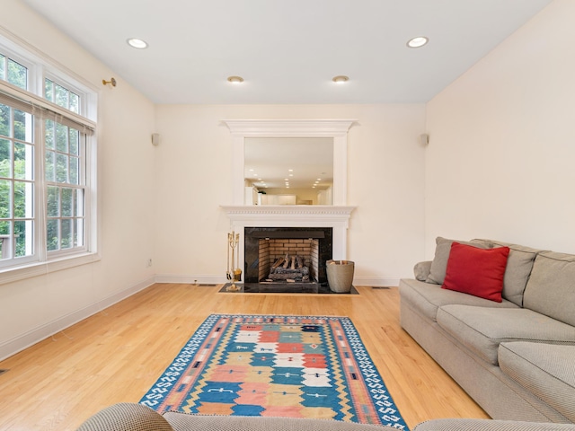 9 Autumn Leaves Rd, Wallingford, CT 06492 - living area with wood finished floors, a fireplace with flush hearth, and recessed lighting